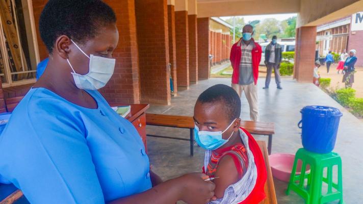 Child being vaccinated by a nurse