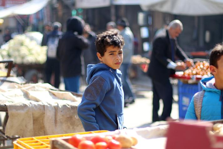 Boy in front of a grocery stall